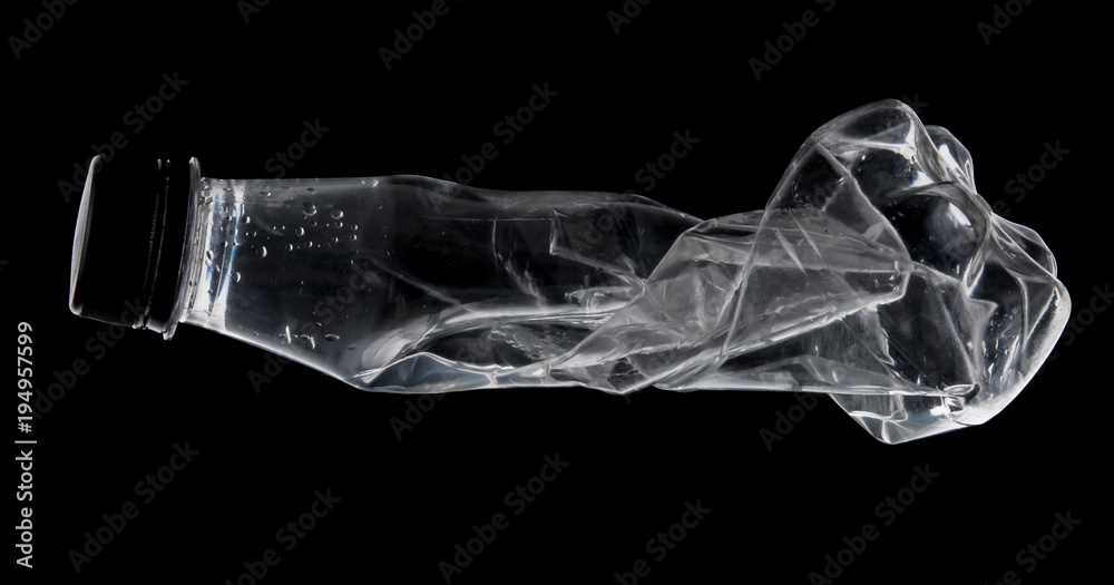 Empty used water bottle for recycling over dark background