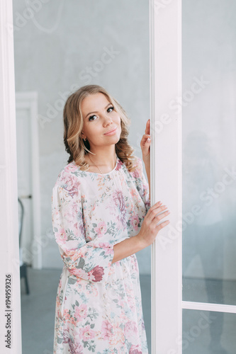 beautiful young blonde woman in nice spring dress, elegant black sunglasses posing in a studio. Fashion spring summer photo