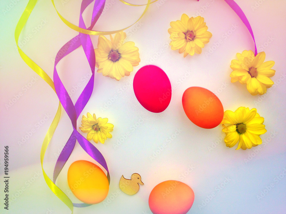 Easter concept background. Pink and orange eggs, yellow chrysanthemums, multicolored ribbons. Copy space. Bokeh effect. Toning effect Easter concept background. Pink and orange eggs, yellow chrysanthemums, multicolored ribbons. Copy space. Bokeh effect. Toning effect