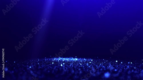 Blue glittering particles with spotlights and blurred background. UHD 4K seamless loop video. photo