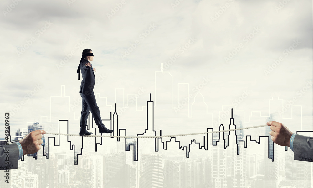 Business concept of risk support and assistance with man balancing on rope Business concept of risk support and assistance with man balancing on rope