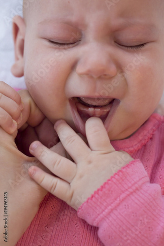 baby crying .teeth growing . selective focus