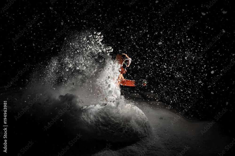Fototapeta premium Freeride snowboarder jumping in snow at night