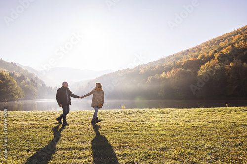 Senior couple on a walk in an autumn nature.