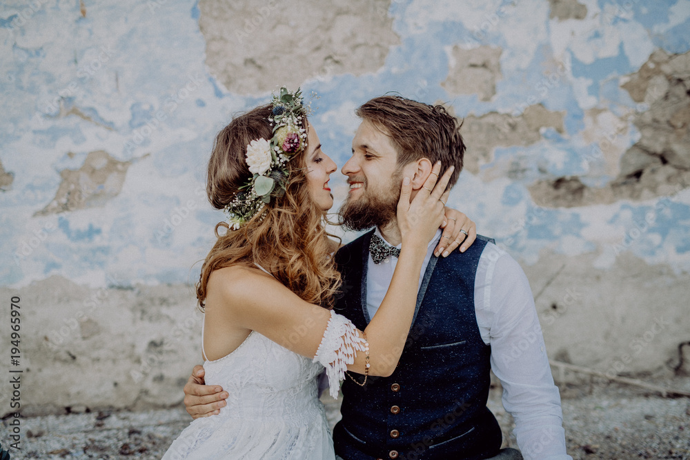 Beautiful bride and groom in front of old shabby house. Beautiful bride and groom in front of old shabby house.