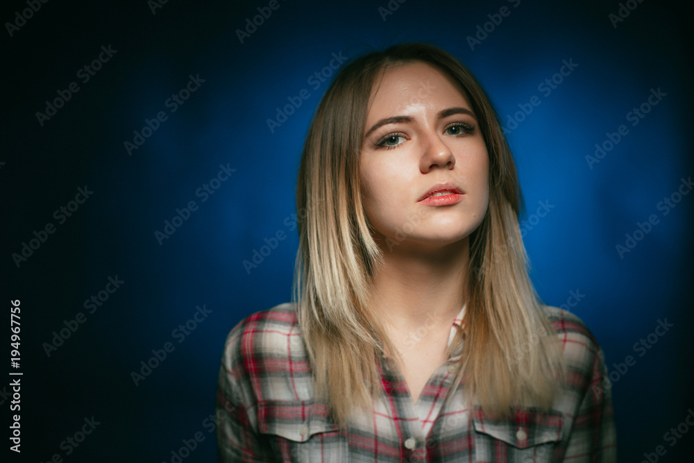 portrait smiling girl on blue background in studio portrait smiling girl on blue background in studio