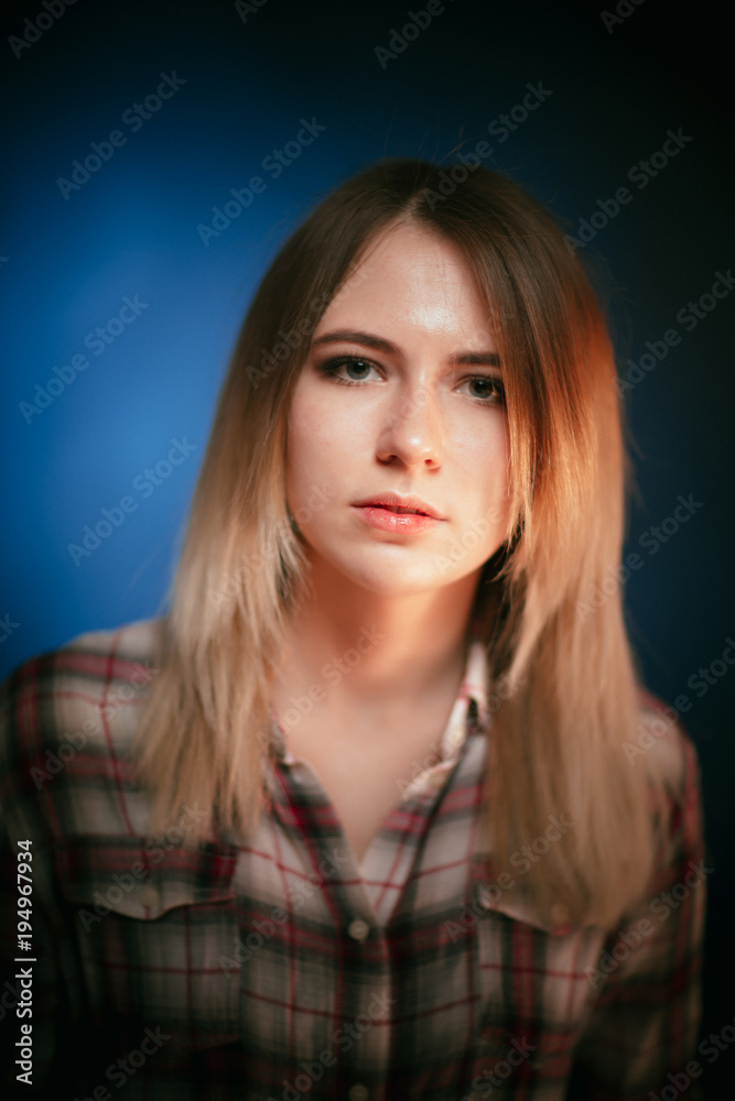 portrait smiling girl on blue background in studio portrait smiling girl on blue background in studio