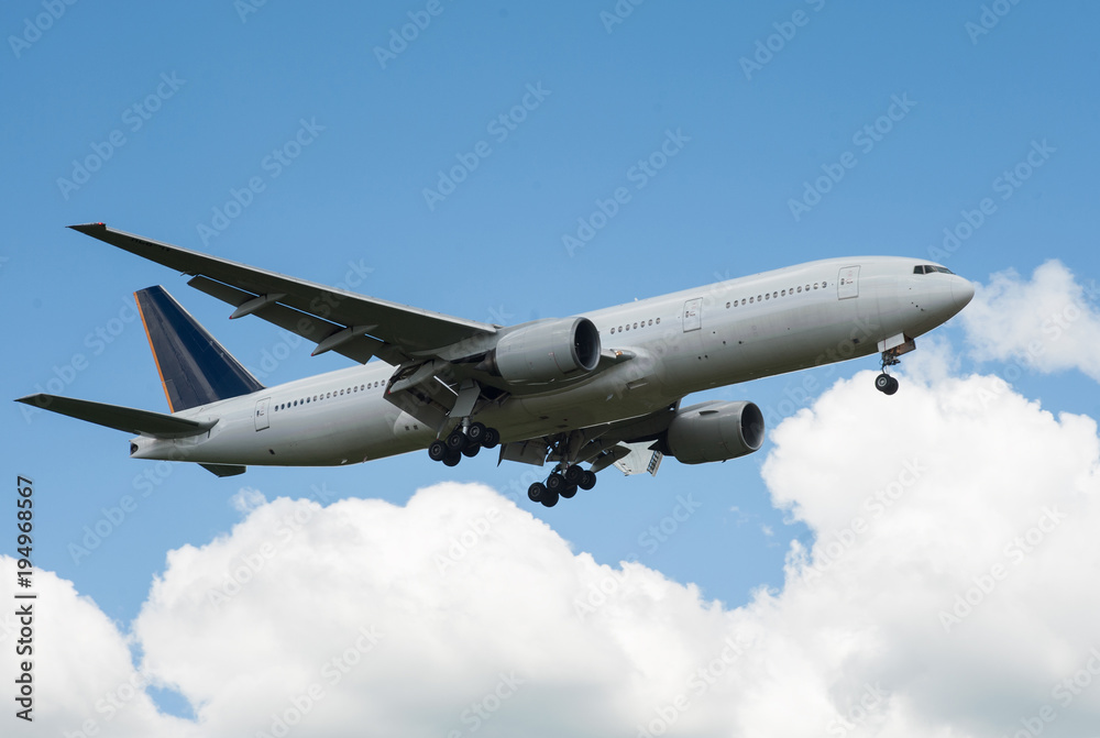 The plane on a background of blue sky and white clouds. The plane on a background of blue sky and white clouds.