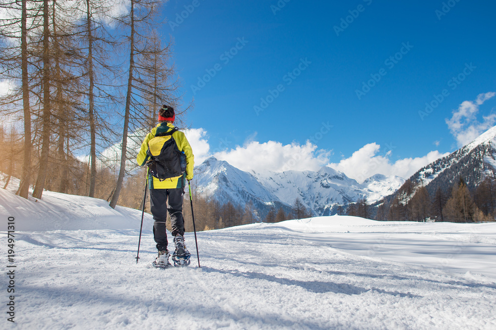 A girl walks with snowshoes in solitude