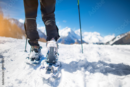 Walk with snowshoes in the snow during mountain holidays photo