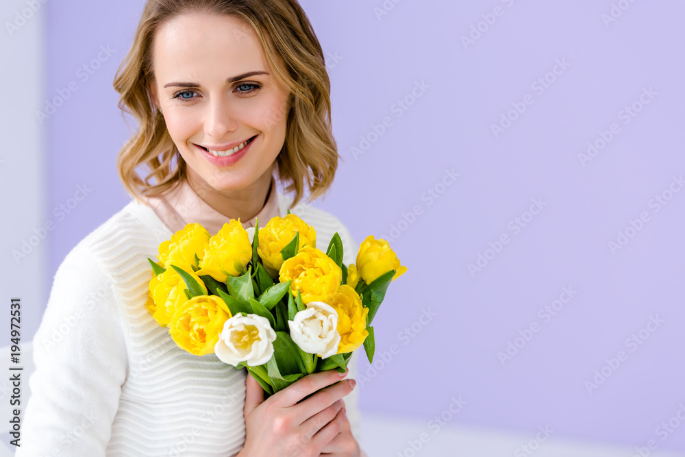 Attractive young woman holding tulips for women's day Attractive young woman holding tulips for women's day
