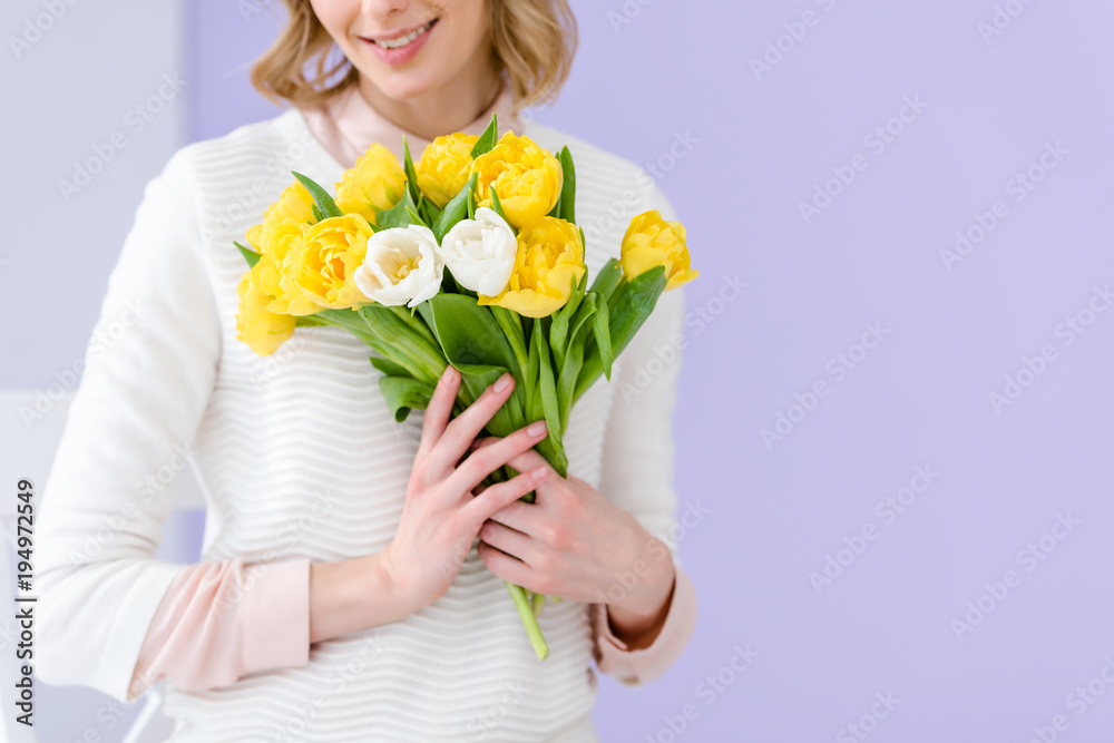 Close-up view of woman holding bouquet of tulips for women's day Close-up view of woman holding bouquet of tulips for women's day