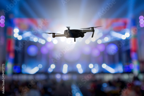 flying drone recording event by video camera at night concert