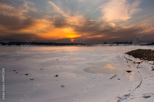 Sunset at frozen dam