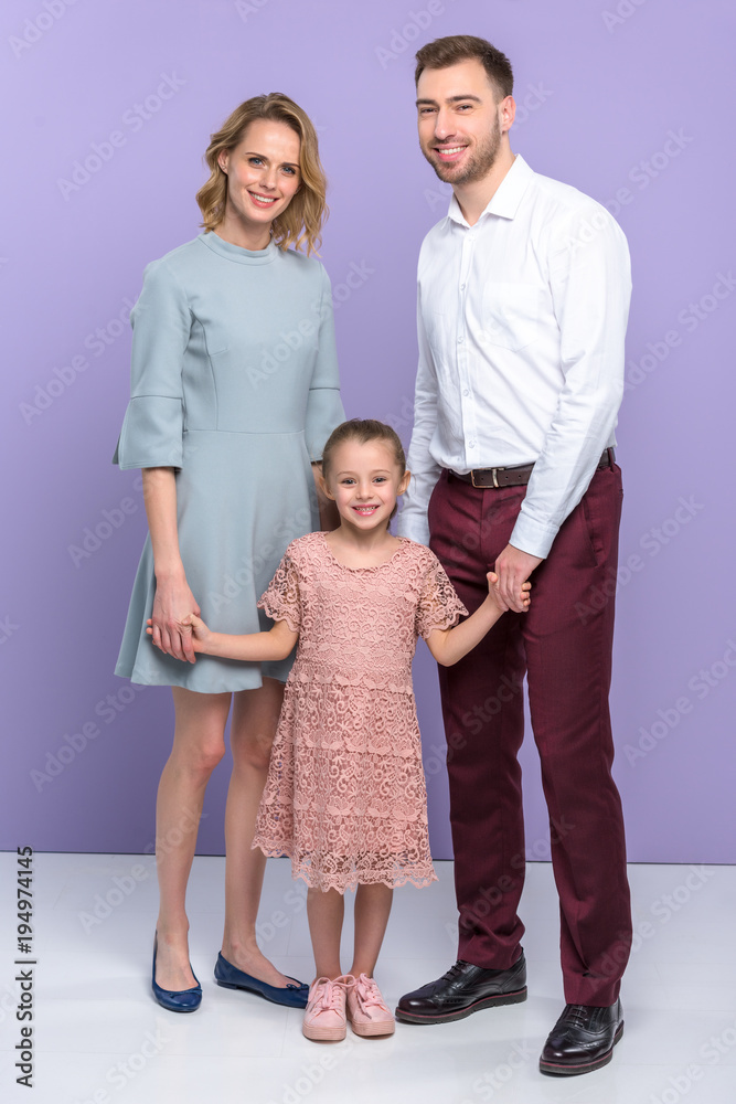 Adorable family with daughter on violet background Adorable family with daughter on violet background