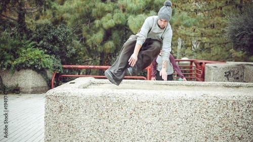 Playful freerunners having fun on street. Parkour photo