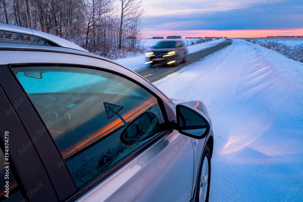 Driving SUV car in winter on forest road with much snow. oncoming car at a dangerous speed. dangerous snow-covered road. a risky driver