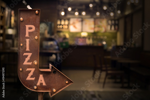 Pizza shop signboard, in front of the store . Retro style photo