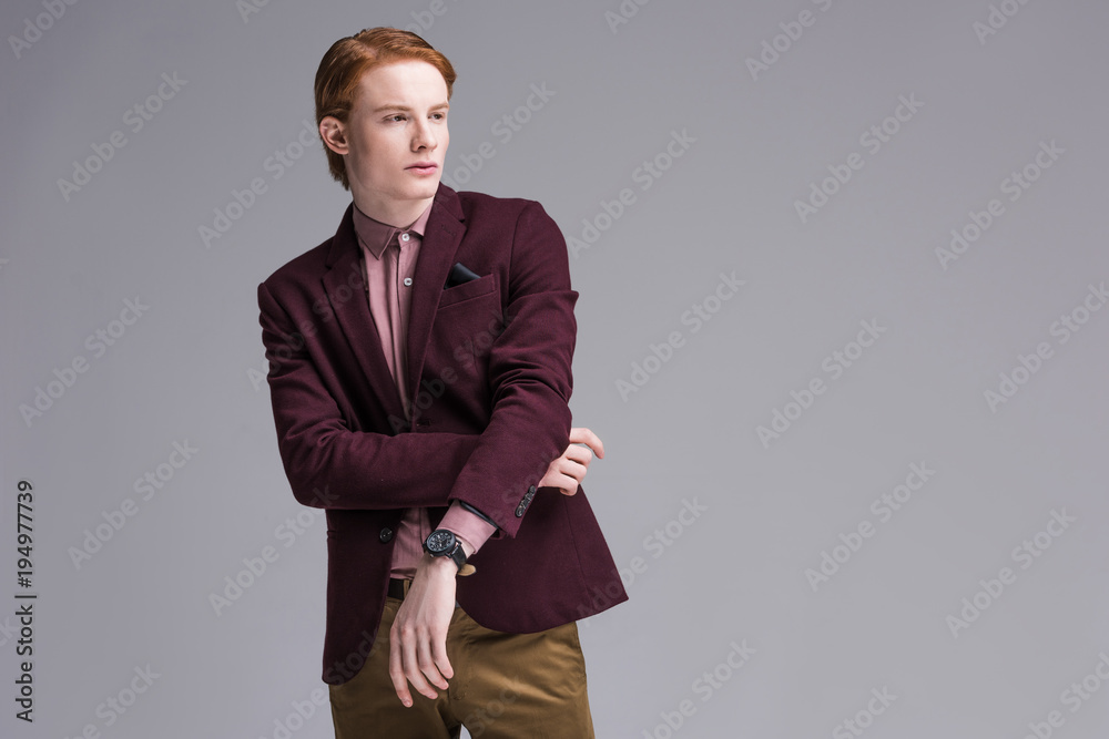 Young stylish man dressed in jacket isolated on grey Young stylish man dressed in jacket isolated on grey