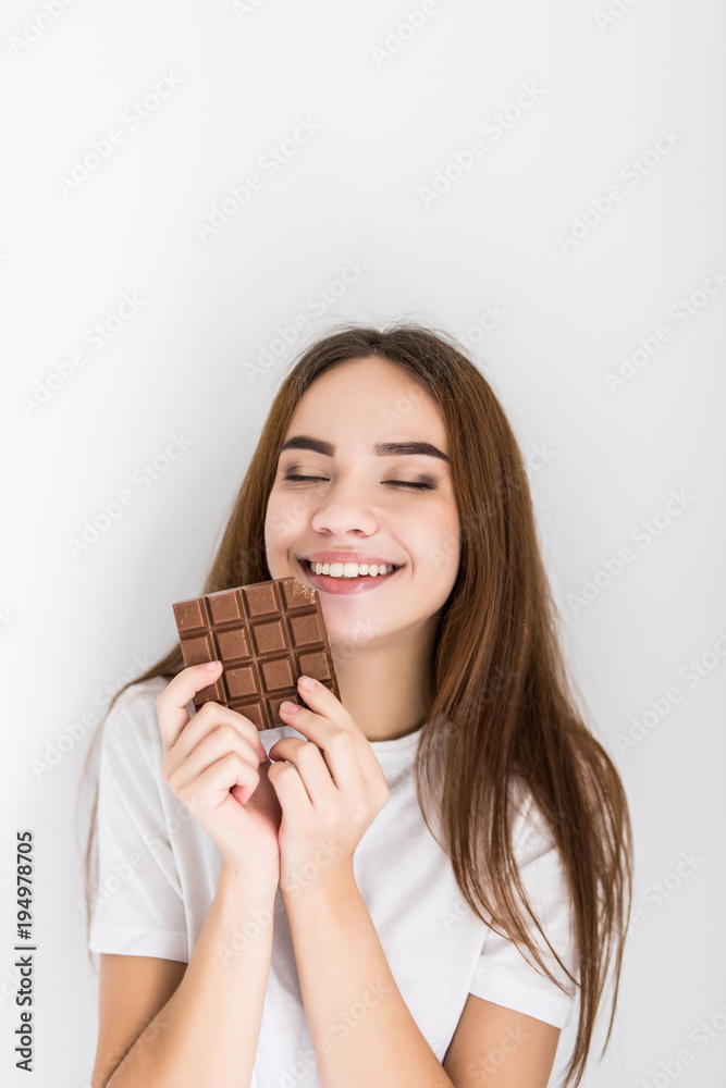 Young woman snacking on a bar of chocolate Young woman snacking on a bar of chocolate