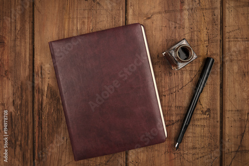 A leather bound journal, and ink well and pen