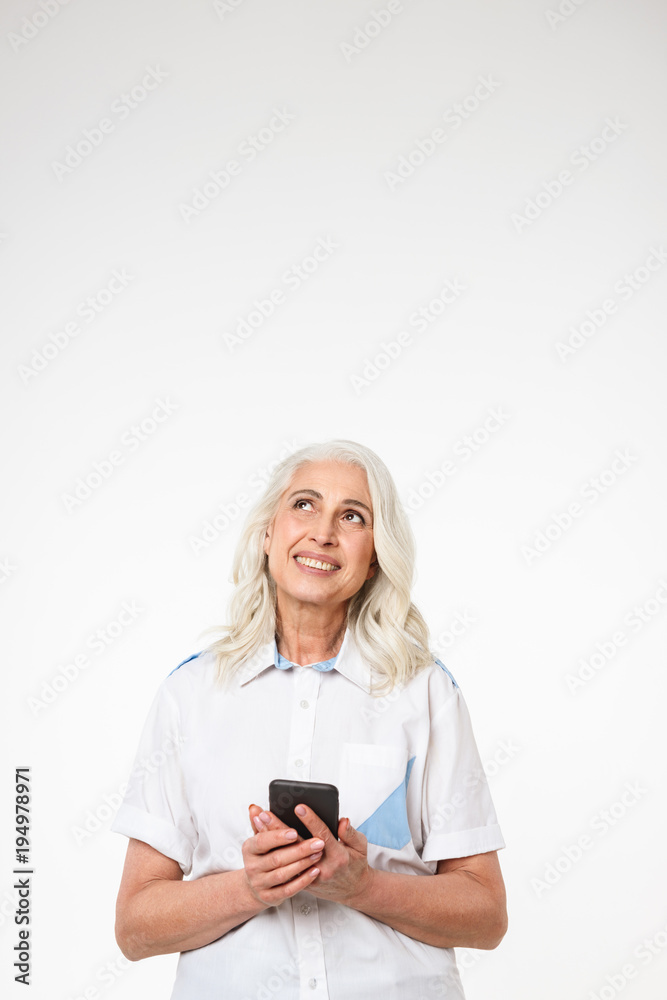 Portrait of a pensive mature woman holding mobile phone Portrait of a pensive mature woman holding mobile phone