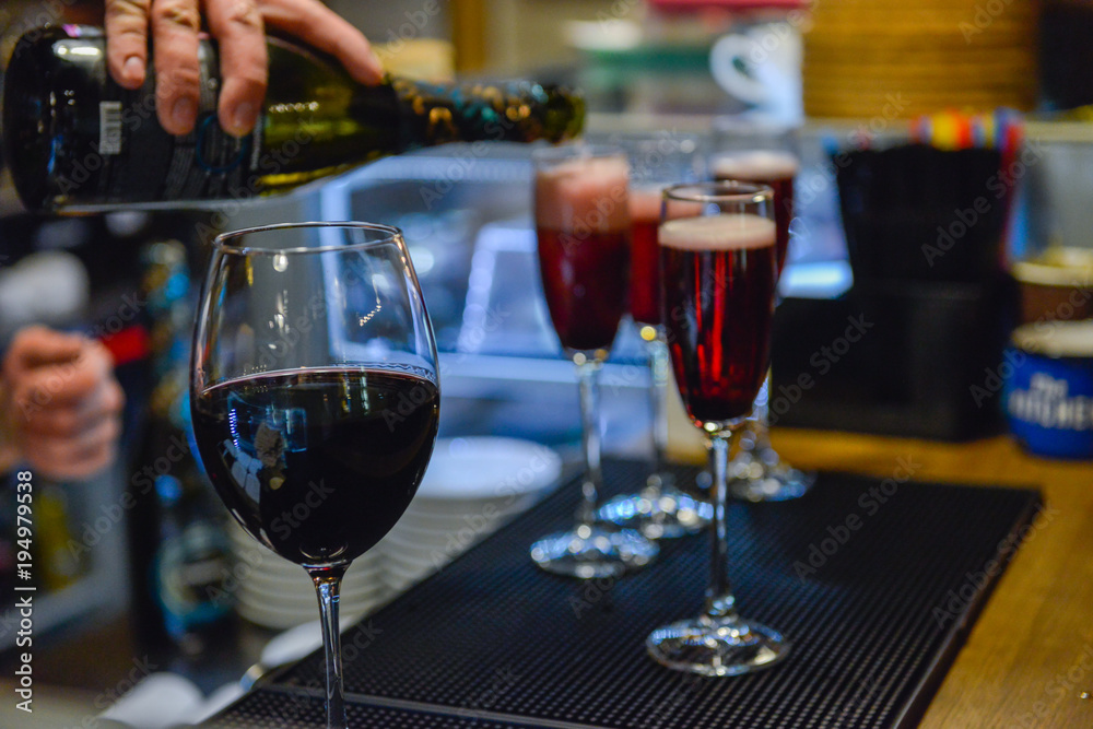 Wine pouring into the glasses on bar Wine pouring into the glasses on bar