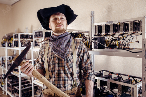 Canvastavla Man as a gold prospector with a tool on the background of computer devices