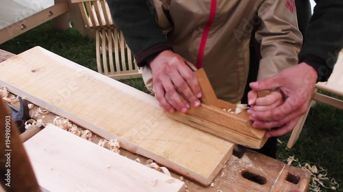 The joiner and the apprentice. Working with wood. photo