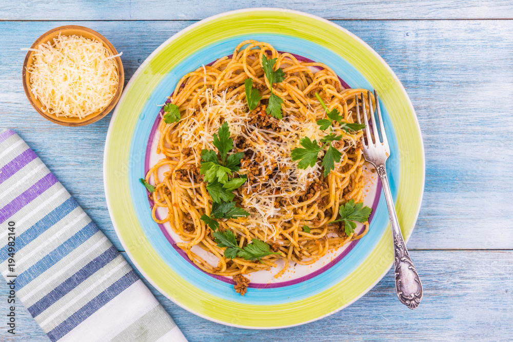 Spaghetti bolognese with cheese and celery leaves top view Stock