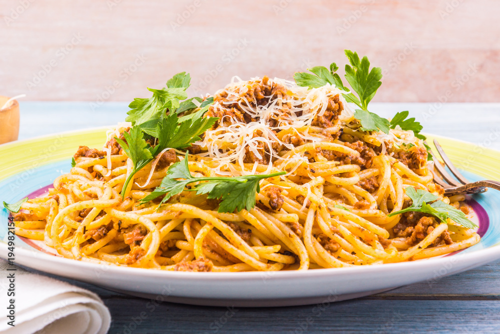 Spaghetti bolognese with cheese close-up on a rustic light background Spaghetti bolognese with cheese close-up on a rustic light background