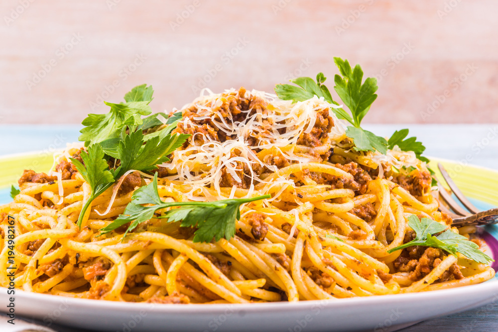 Spaghetti bolognese with cheese close-up on a rustic light background Spaghetti bolognese with cheese close-up on a rustic light background