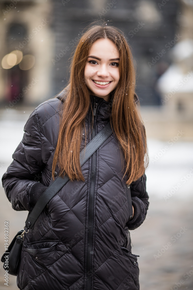 Outdoor portrait. Young beautiful happy smiling girl walking on street. Outdoor portrait. Young beautiful happy smiling girl walking on street.