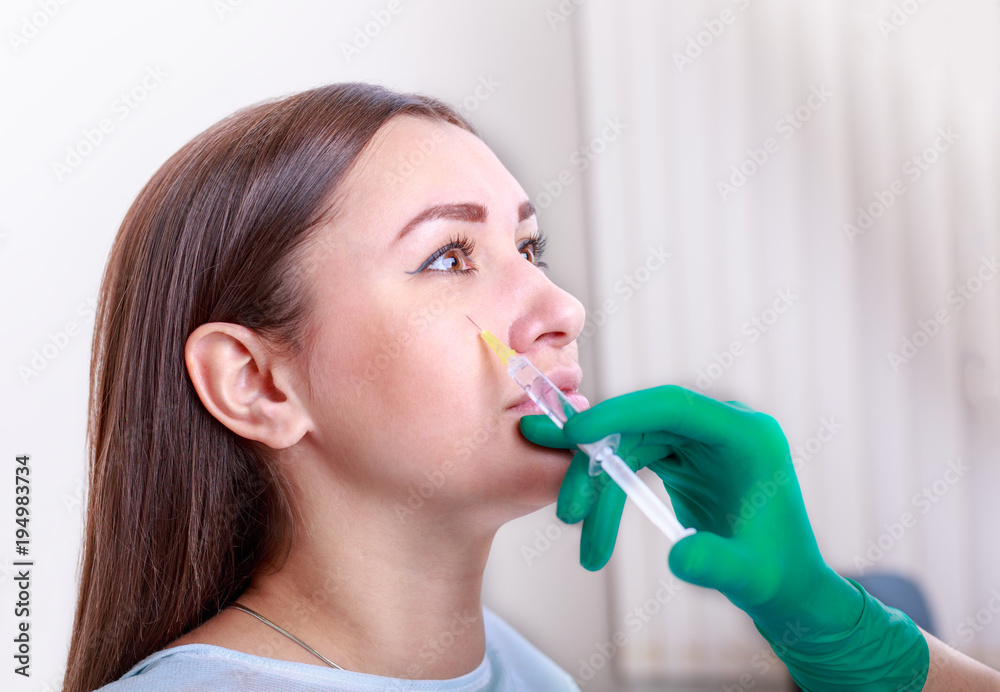 Cosmetic injection of to the pretty female face Cosmetic injection of to the pretty female face