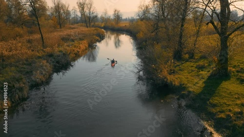 Wallpaper Mural Medium aerial tracking shot of red kayak paddling on calm river on a beautiful autumn day.
 Torontodigital.ca