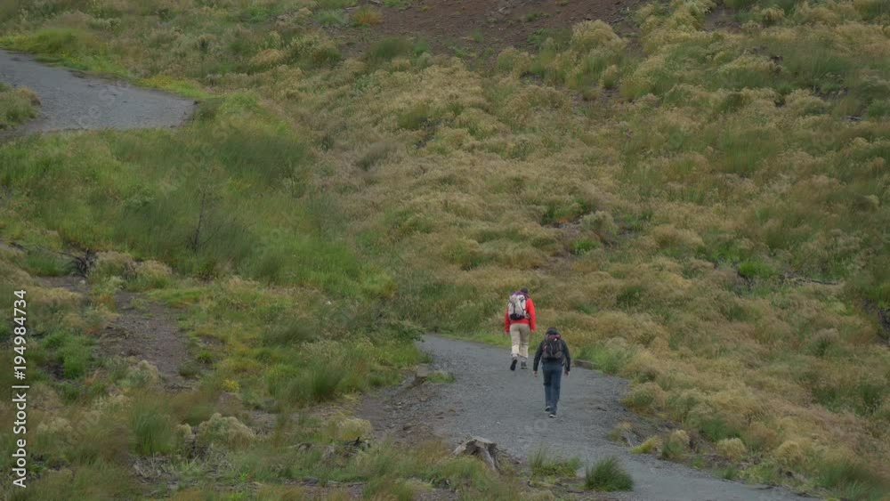 Two people on a hiking trail Two people on a hiking trail