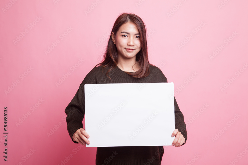 Young Asian woman with white blank sign. Young Asian woman with white blank sign.
