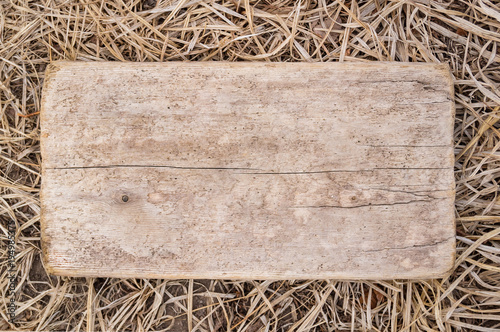 Wooden plaque on the background of a dry autumn grass