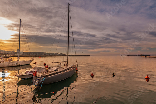 Pleasure boats moored in harbor.