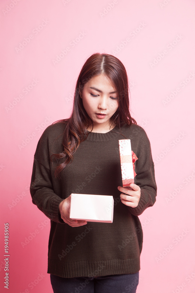 Young Asian woman open a gift box. Young Asian woman open a gift box.