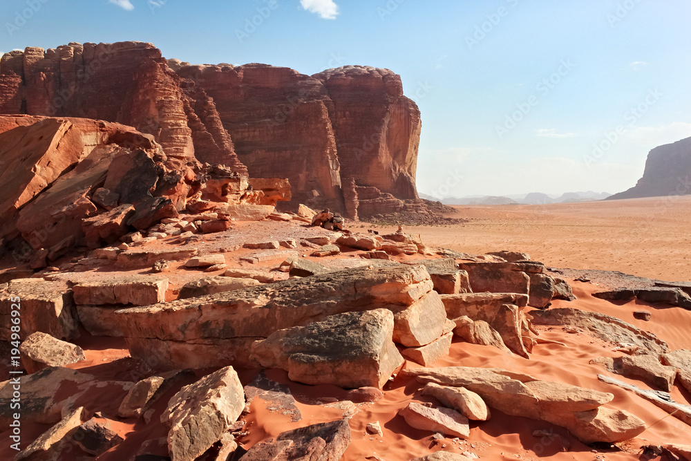 Red mountains of the canyon of Wadi Rum desert in Jordan. Wadi Rum also known as The Valley of the Moon is a valley cut into the sandstone and granite rock in southern Jordan to the east of Aqaba.