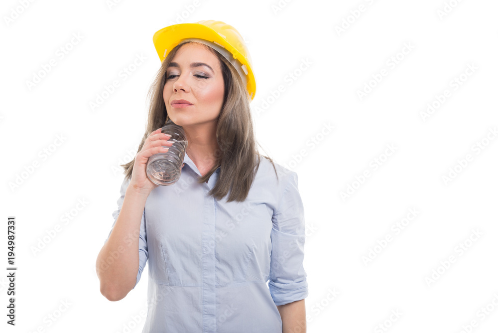 Female constructor chilling herself with bottle of water. Female constructor chilling herself with bottle of water.