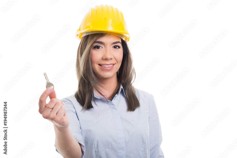 Portrait of female constructor showing one key. Portrait of female constructor showing one key.