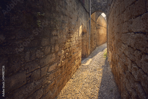 Narrow cabblestone walking street in old city of Rhodes