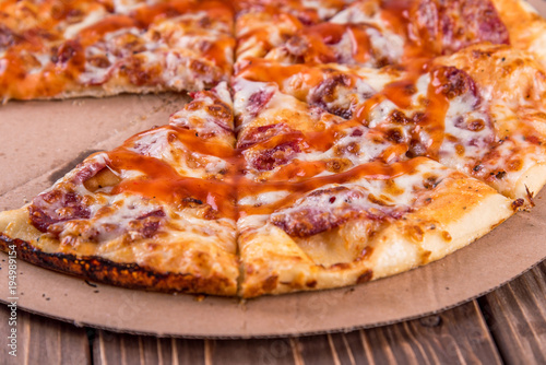 Pepperoni pizza on rustic background.