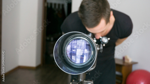 Man looking in telescope