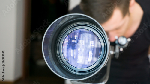 Man looking in telescope