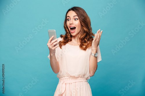 Portrait of an excited beautiful girl wearing dress