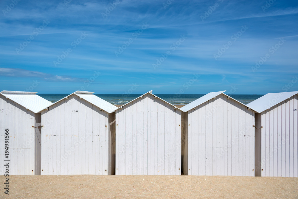 Traditional white wooden beach huts on the beach of Villers, Normandy, France Traditional white wooden beach huts on the beach of Villers, Normandy, France
