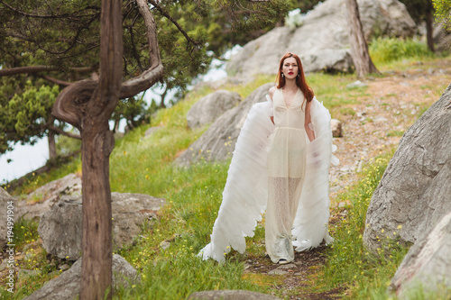 Bilde på lerret Girl with white wings wander in the woods